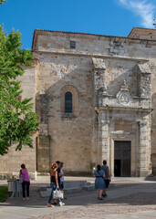 People walking in a square near a historic church, zamora city, spain
