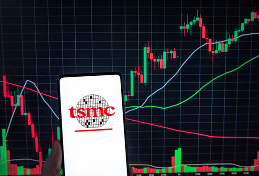 TSMC logo on smartphone infront of random chart. Link&ouml;ping, &Ouml;sterg&ouml;tland, Sweden. 01-22-2026.
