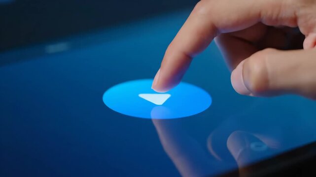 Digital Interface Control - A person's finger presses a bright play button on a modern computer screen, activating a function.