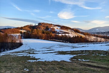 partially snowy hill and field