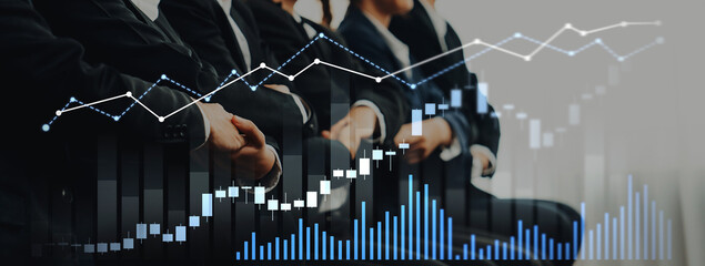 A business team engages in analyzing financial data while stock market graphs illustrate growth trends and market fluctuations in a contemporary office setting. Scalp