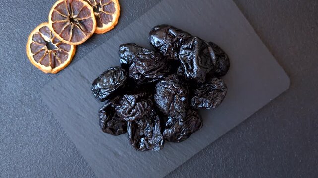 Sweet dried plums or prunes, organic dehydrated fruit for dietary nutrition. Prunes or dried plums as a food background for your design