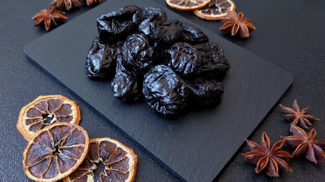 Sweet dried plums or prunes, organic dehydrated fruit for dietary nutrition. Prunes or dried plums as a food background for your design