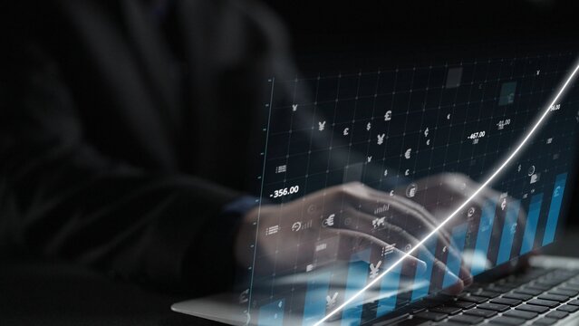A focused businessman interacts with a laptop, showcasing digital graphs and data visualizations to analyze financial trends and make informed decisions. Copula - Powered by Adobe