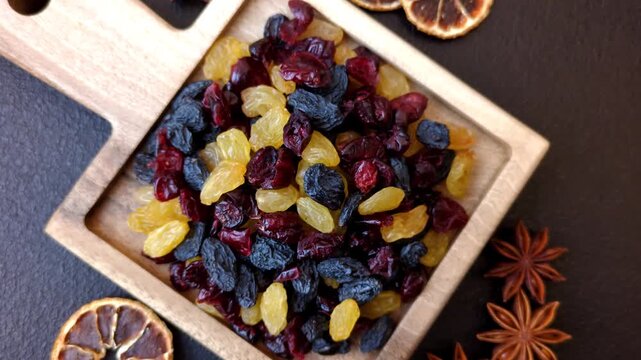 Dried cranberries, yellow and black sweet raisins as ingredients for granola and breakfast. Raisins and cranberries as a food background for your design