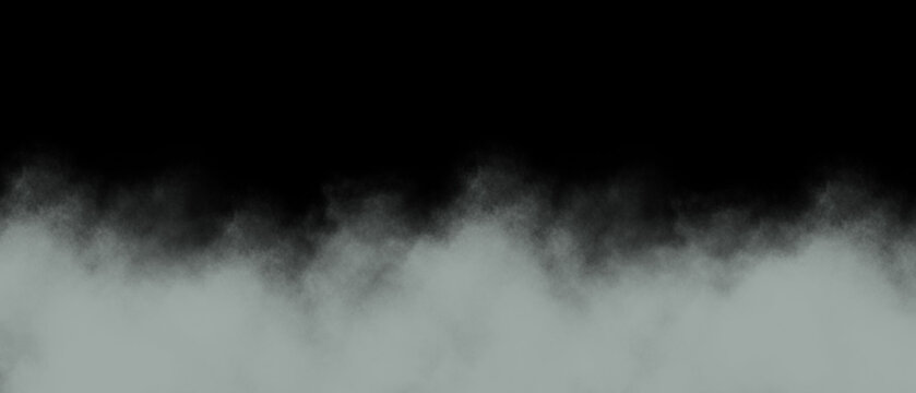 Atmospheric low lying grey and white smoke or fog spreading across the bottom of a stark black background creating a moody and mysterious visual effect for overlays