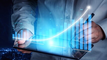 A businessman holds a tablet displaying financial data charts and graphs, representing growth in a rapidly changing market amid a nighttime city backdrop. Copula