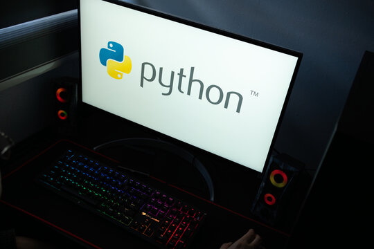 Punta Arenas, Chile &ndash; January 20, 2026: High-angle view of the Python programming language logo on a PC screen with a backlit mechanical keyboard
