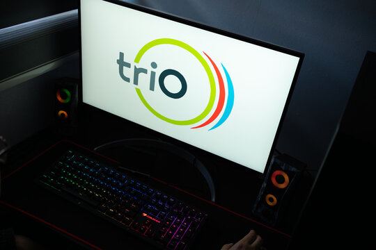 Punta Arenas, Chile &ndash; January 20, 2026: A desktop monitor featuring the stylized Trio logo alongside glowing computer peripherals and RGB lighting