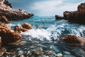 Waves crash against the rocky shore, creating a mesmerizing display of the ocean's power, highlighting the coast's natural beauty and the allure of the sea