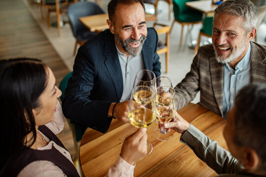 Business colleagues toasting with wine in restaurant