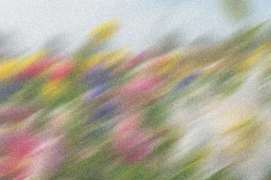 Artistic motion blur background with grainy texture and multicolored floral hues suitable for soft romantic themes or posters