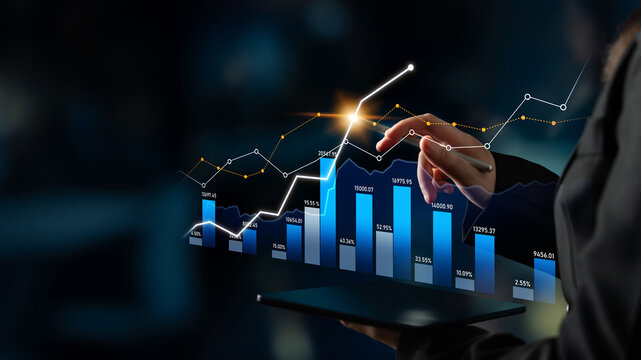 A businesswoman interacts with a tablet displaying graph data and trends. The image captures the essence of modern technology and financial analysis in a professional setting. Scalp - Powered by Adobe