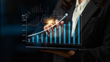A professional businesswoman showcases data analytics using a touchscreen interface, highlighting growth through dynamic graphs and charts in a modern office environment. Scalp