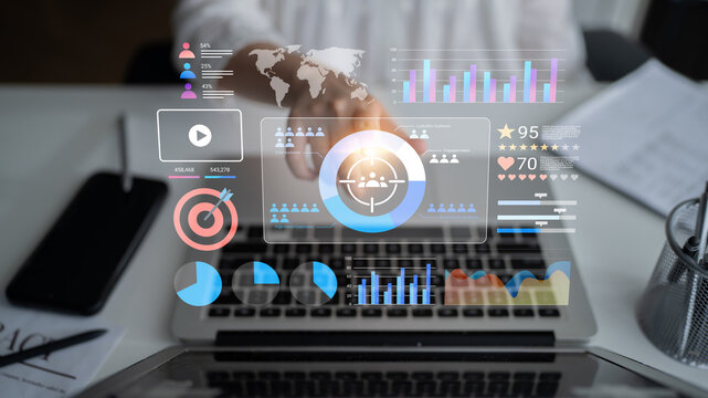 Digital interaction with futuristic data visualizations on a laptop screen. Explore insights and analytics through vibrant graphs and charts in a modern workspace. Gantry