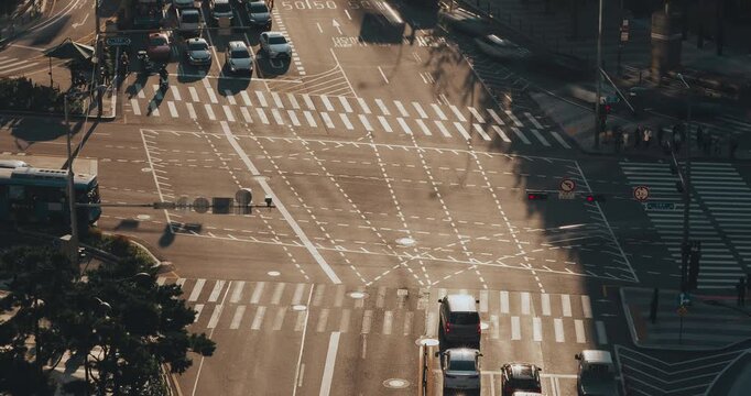 Three frames depict the continuous movement of vehicles through city intersections, showcasing traffic patterns and urban dynamics. Time-lapse, Seoul, South Korea