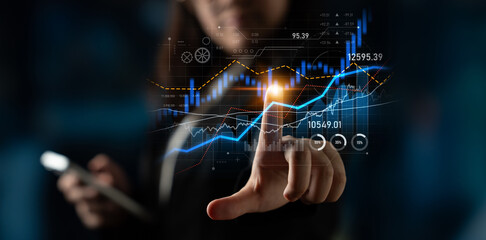A business professional engages with dynamic financial data displayed on a screen while using a smartphone to enhance decision-making and performance analysis. Scalp