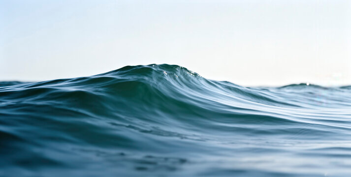 A beautiful ocean wave crests with turquoise hues, creating a serene yet powerful scene perfect for various design projects. This image evokes feelings of tranquility and natural beauty.