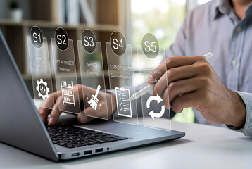 Person writing on transparent screen with five step process above laptop hand
