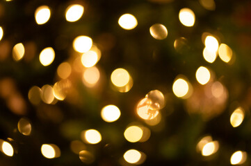Obraz premium Gold bokeh Christmas lights with amber abstract background