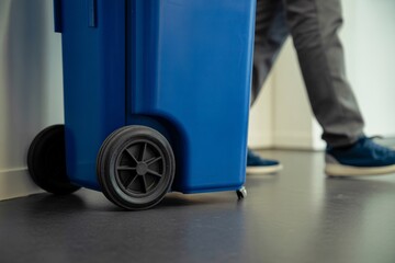 Blue trash bin in modern office interior. Closeup shot of blue trash.
