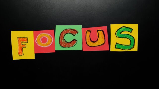 Focus emerging from chaos as scattered letters are arranged by hands into the word focus, symbol of mental clarity, concentration, decision making and structured thinking in modern work and life