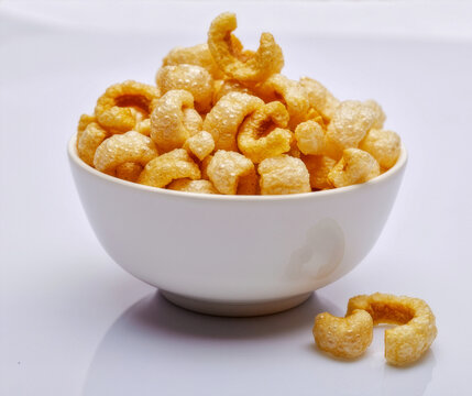 Crispy Pork Rinds in White Bowl Traditional Snack Isolated