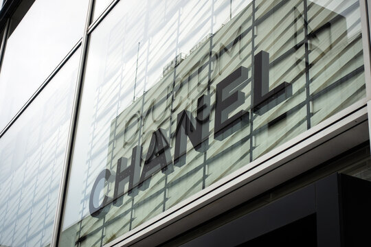 Tokyo, Japan - May 28, 2019: Chanel logo reflected on a modern glass building facade. Chanel is a a French luxury fashion house founded in 1910 by Coco Chanel in Paris.