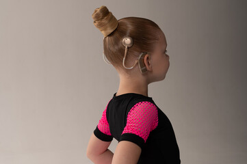 Child head with cochlear implant hearing aid. Copy space