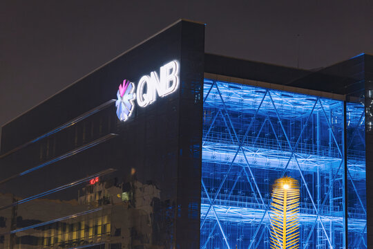 29 November 2025, Doha, Qatar: QNB headquarters building glowing with bright blue lights, representing finance and banking