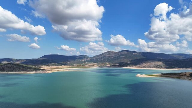 Aerial drone cinematic video of artificial lake of Yliki in Boeotia prefecture with calm waters and beautiful clouds, an important source of drinking water for the Athens, Greece