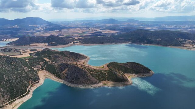 Aerial drone cinematic video of artificial lake of Yliki in Boeotia prefecture with calm waters and beautiful clouds, an important source of drinking water for the Athens, Greece