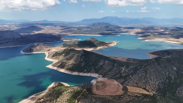 Aerial drone cinematic video of artificial lake of Yliki in Boeotia prefecture with calm waters and beautiful clouds, an important source of drinking water for the Athens, Greece