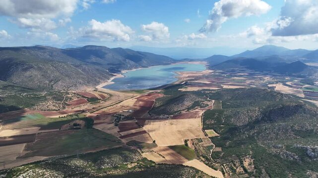 Aerial drone cinematic video of artificial lake of Yliki in Boeotia prefecture with calm waters and beautiful clouds, an important source of drinking water for the Athens, Greece