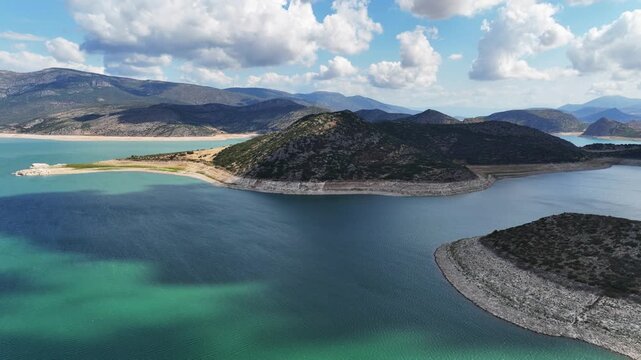 Aerial drone cinematic video of artificial lake of Yliki in Boeotia prefecture with calm waters and beautiful clouds, an important source of drinking water for the Athens, Greece