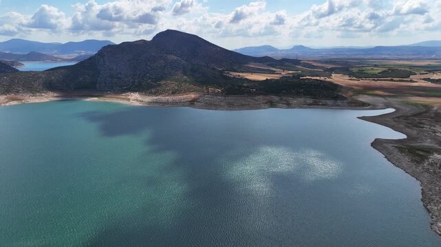 Aerial drone cinematic video of artificial lake of Yliki in Boeotia prefecture with calm waters and beautiful clouds, an important source of drinking water for the Athens, Greece