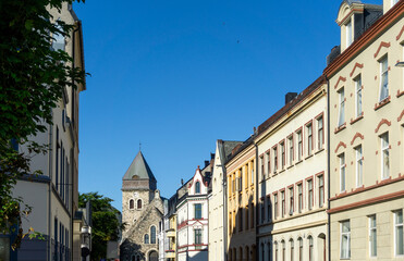 Fototapeta premium Historic Art Nouveau Street View in Ålesund Norway Leading to Stone Church Tower