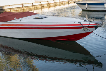 tied speedboat in red and white color