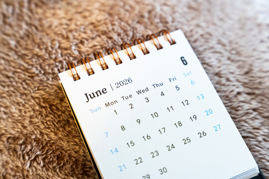 Close-up of a calendar page displaying June 2026 with dates clearly marked, set against a soft background, symbolizing planning and organization for upcoming events.