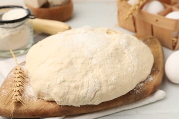 Fresh yeast dough and ingredients on table, closeup