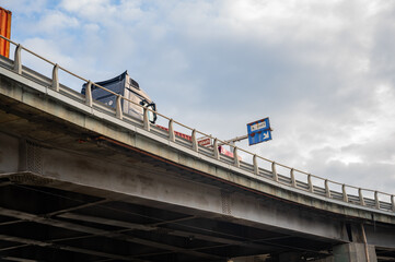 A container truck crossing a bridge on its way to the port. 