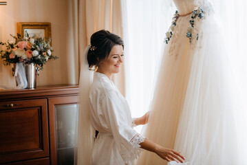 brunette bride in a tight wedding dress in a studio