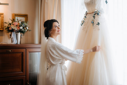 brunette bride in a tight wedding dress in a studio