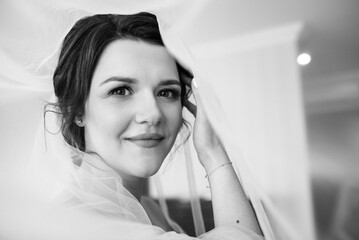 brunette bride in a tight wedding dress in a studio