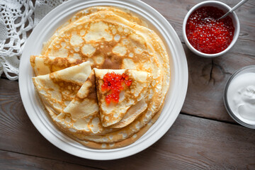 Homemade thin crepes with red caviar