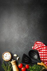 Food background on black. Fresh herbs, spices and vegetables with tablecloth.