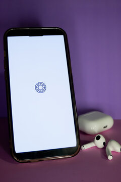 Rosario, Argentina, January 20, 2026: Smartphone with Visco app logo on screen besides airphones, against purple background