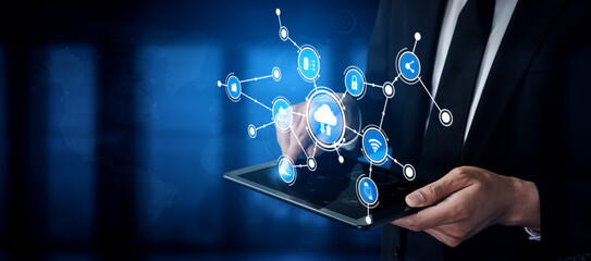 A professional man interacts with a virtual cloud interface using a tablet, showcasing modern technology and innovative data connections in a business setting. Tessel