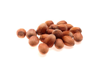 Fototapeta premium Group of whole hazelnuts with smooth brown shells arranged on a white background, showcasing their natural texture and shape for culinary or nutritional use