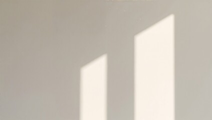 Fototapeta premium Shadows From a Window Fall on a White Wall During the Afternoon Light in a Quiet Room
